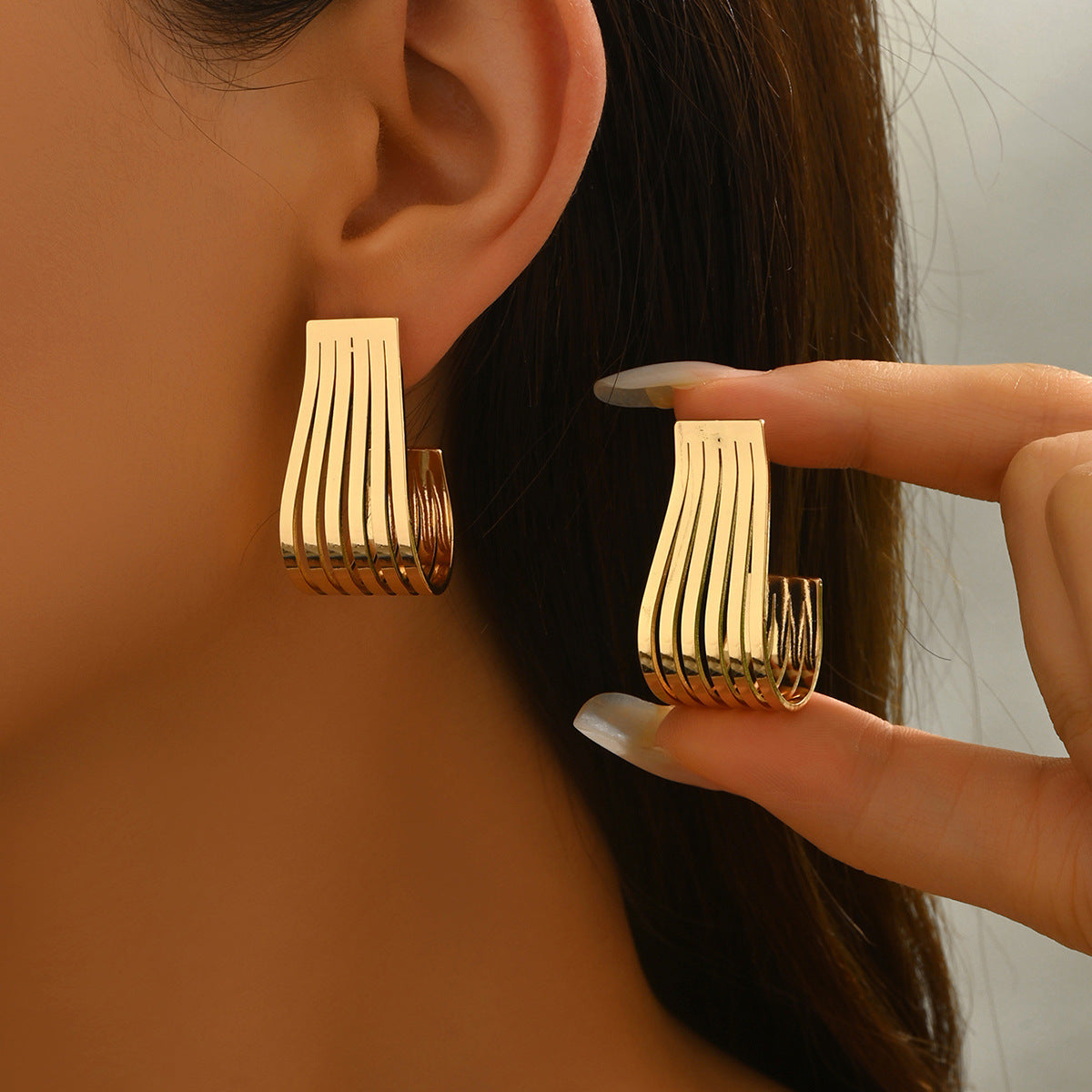 Gold-tone Sculptural Ribbed Earrings from the ANGLOOP jewelry collection